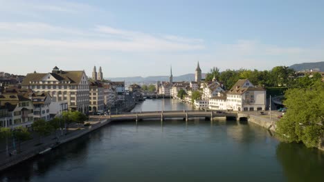 low aerial flight above limmat river in zurich, switzerland on summer morning