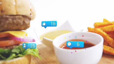 Burger and fries with social media notifications animation over wooden table
