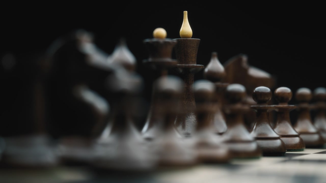 Close up of vintage black chess pieces on a chessboard
