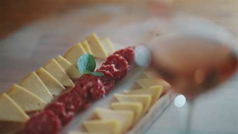 cheese and salami platter paired with a glass of wine at a luxury restaurant dinner