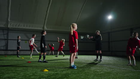 young girls soccer team training indoor