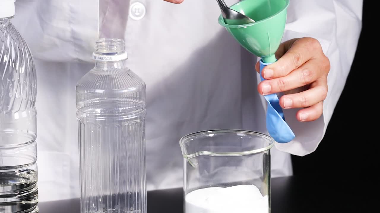 A step-by-step process of adding baking soda to a balloon using a funnel and spoon.