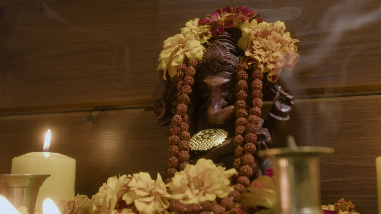 Ganesha Statue with Candles and Flowers