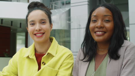 portrait of two cheerful multiethnic businesswomen