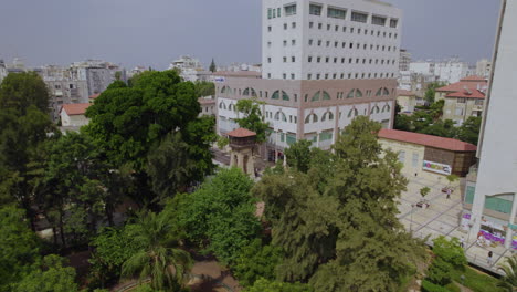 the ancient water tower that was built in 1898 in the young settlement of rishon lezion, is in a beautiful garden with trees and lawns in the center of the city - parallax shot