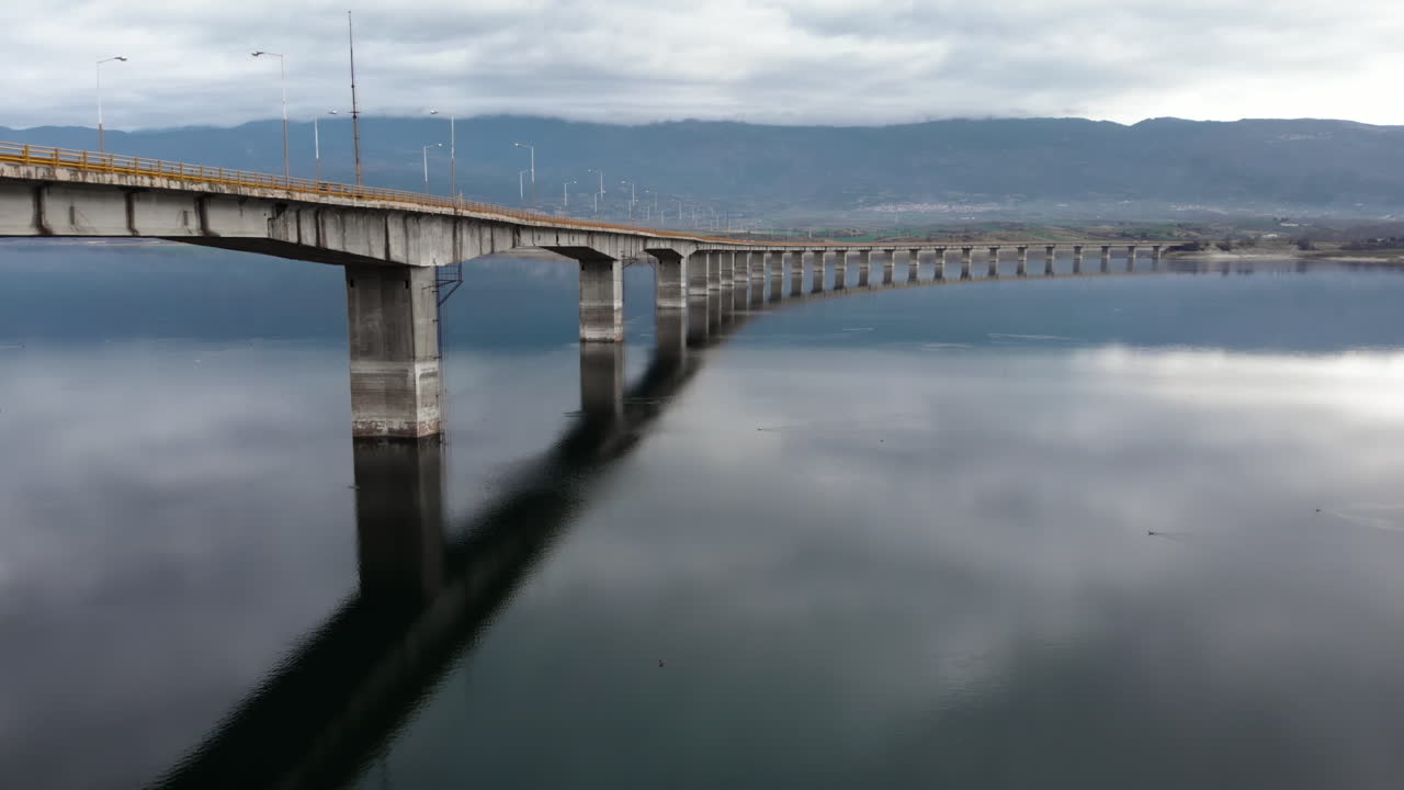 Moody Aerial Tracking Shot of High Bridge at Lake Polyfytos Greece