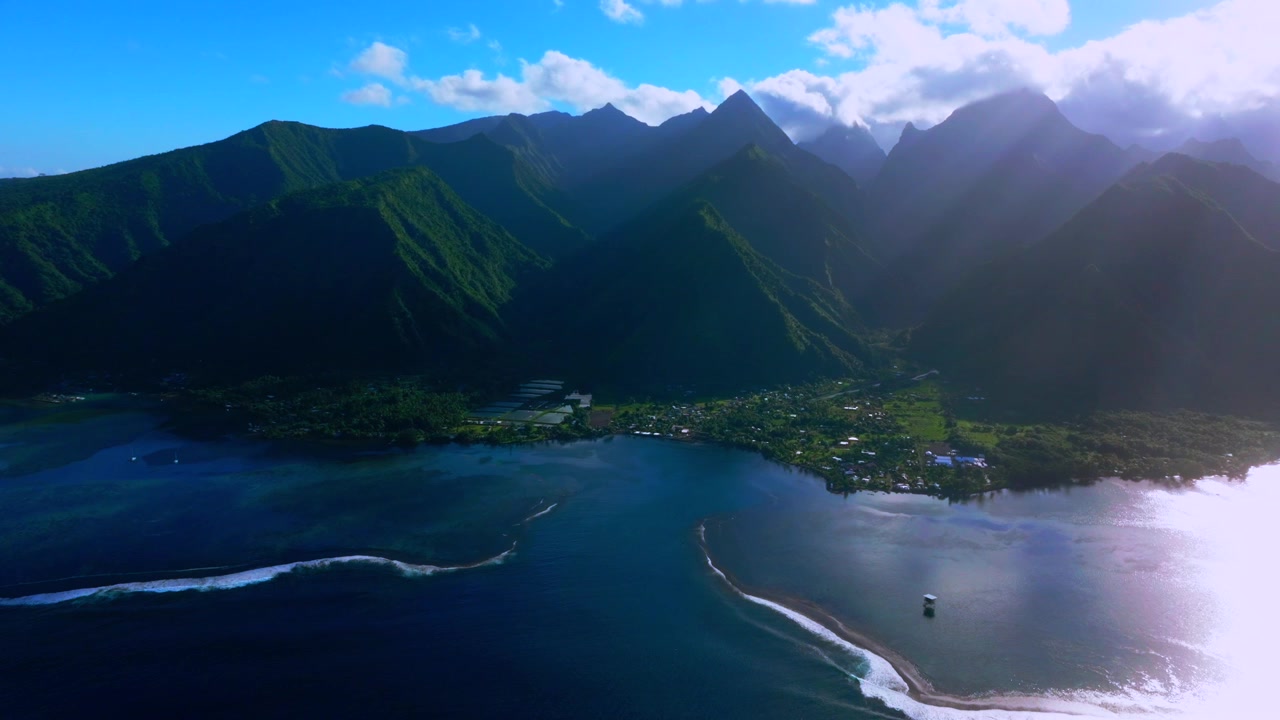 Teahupo'o sunny morning sun rays surf wave lagoon Passe Havea coral reef harbor view Tahiti aerial drone French Polynesia South Pacific Ocean island volcano peaks landscape beach coastline forward