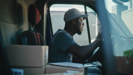 delivery driver experiencing discomfort or back pain in his truck