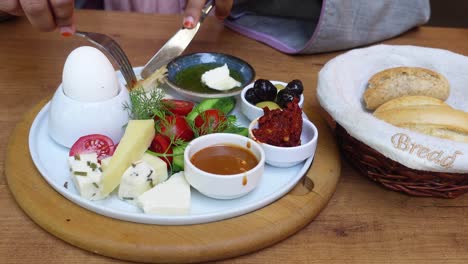 a woman enjoys a delicious turkish breakfast