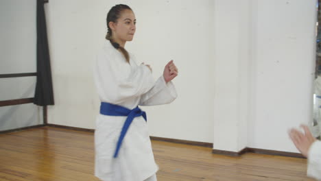 tracking shot of focused girls greeting in bow before training