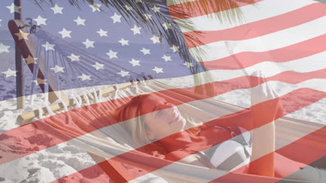 Animation-of-american-flag-waving-over-woman-in-hammock-using-smartphone-on-beach