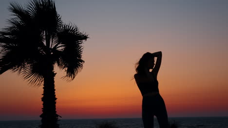 sunset silhouette of a woman on the beach