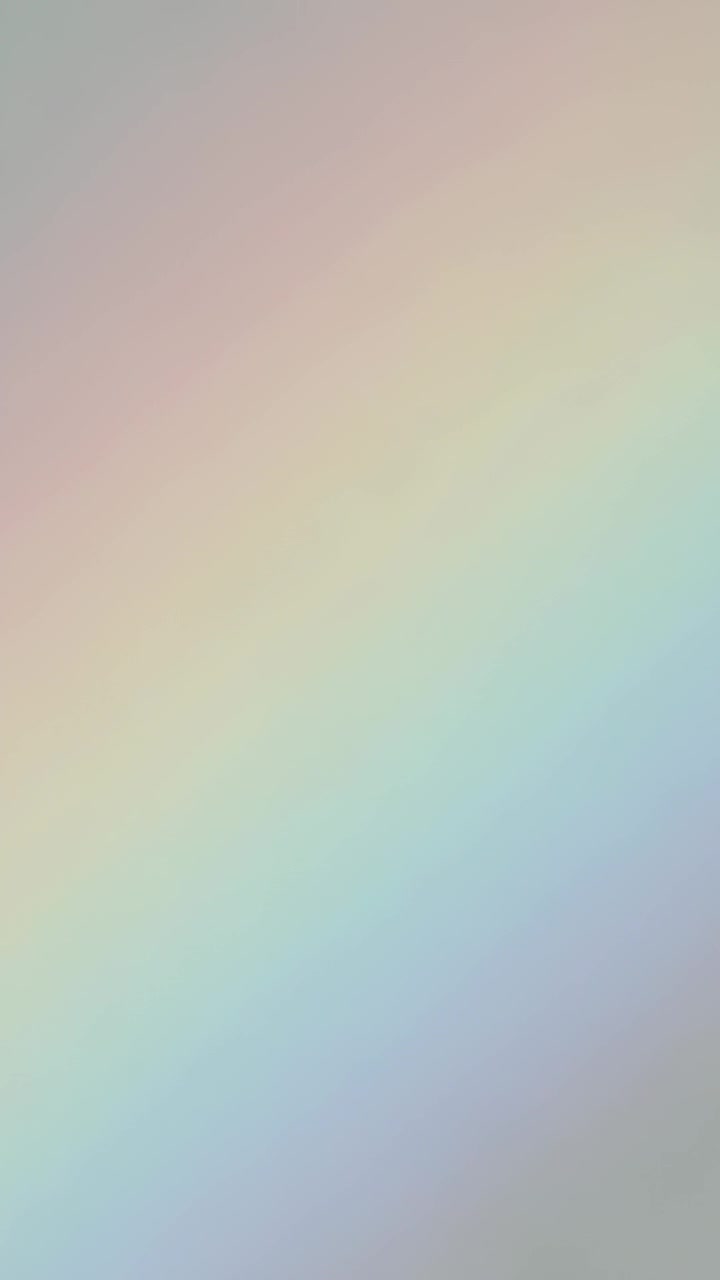 Vertical video: Shifting blurred pastel gradient drifting closeup, changing hue due to light motion
