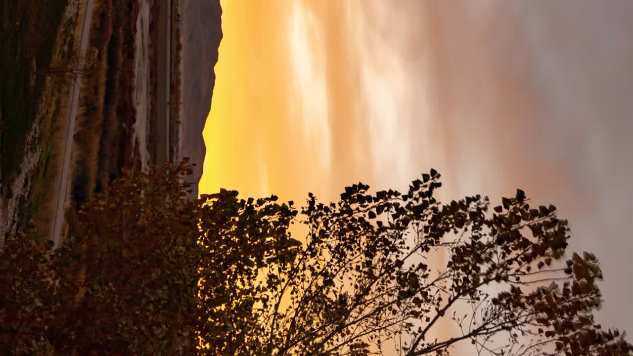 el lapso de tiempo de deslizamiento del atardecer de un parque suburbano - orientación vertical