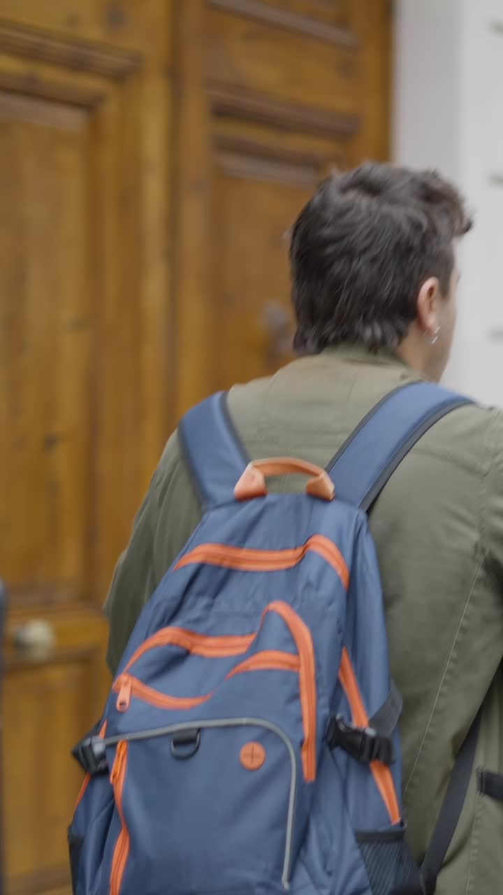 Man walking with a backpack on a city street