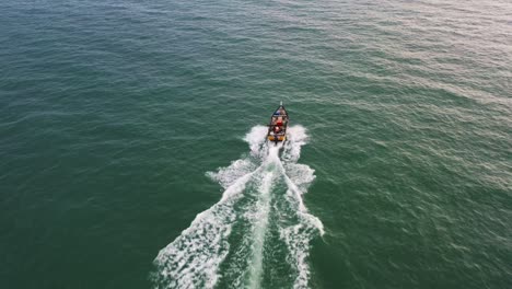 aerial above view capturing small traditional small fishing boat sailing on the sea