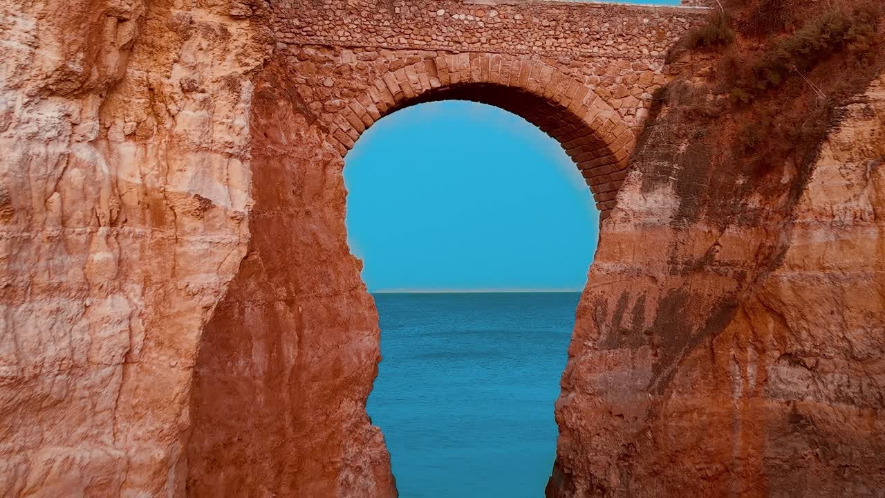 Visit the stunning rock arch by the sea in Portugal at sunset time