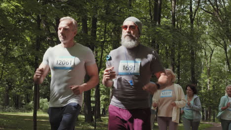 senior citizens running in a park