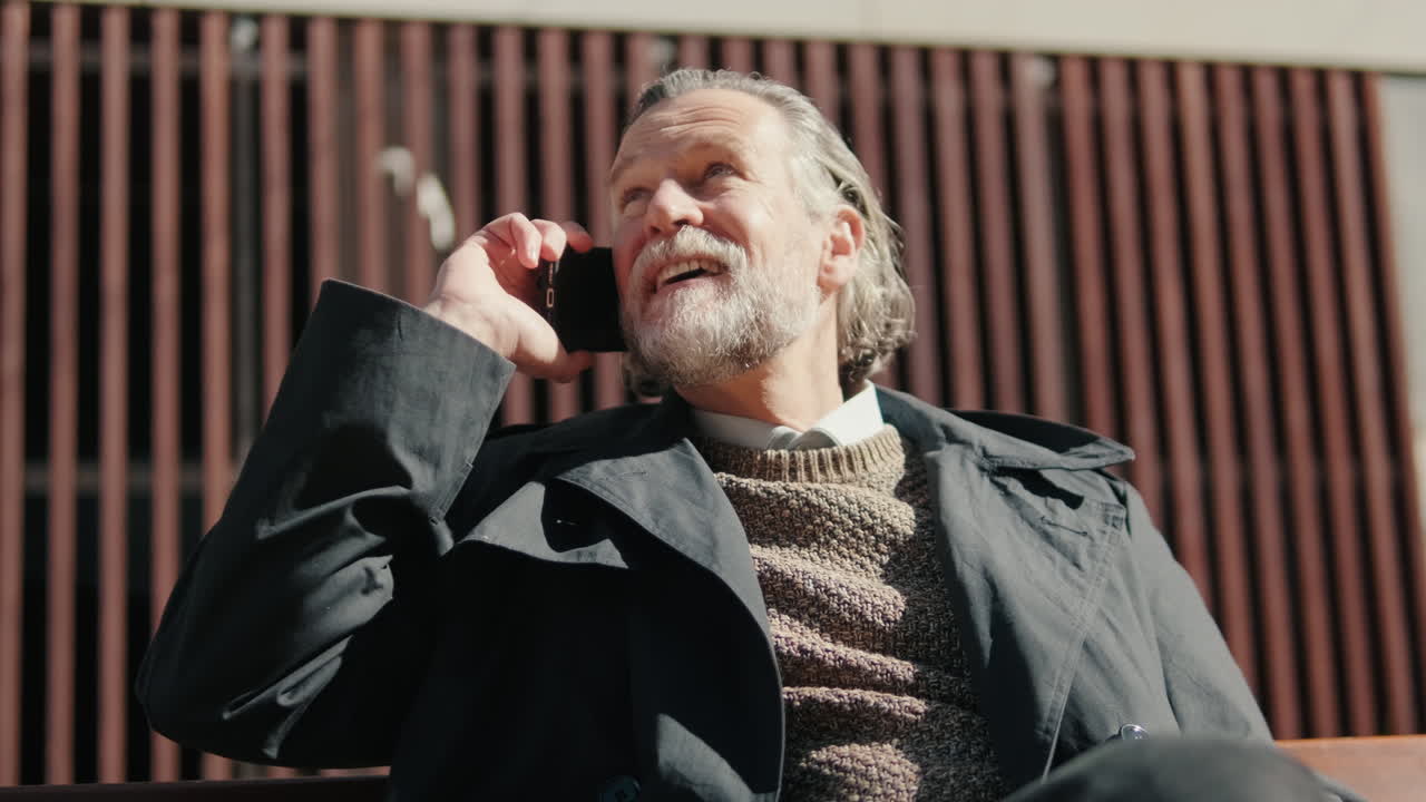 Smiling Man Talks On Phone Outdoors