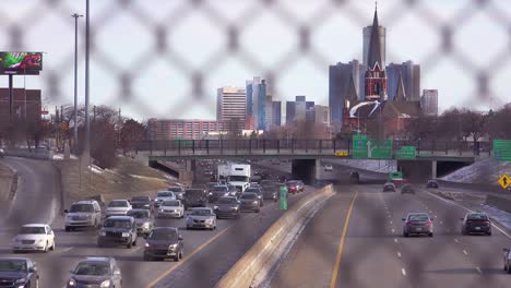 looking through a chain link fence at a large church and freeway near downtown detroit michigan