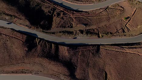 experience the mesmerizing swirl of roads amidst bolivian andes from a top-down drone view