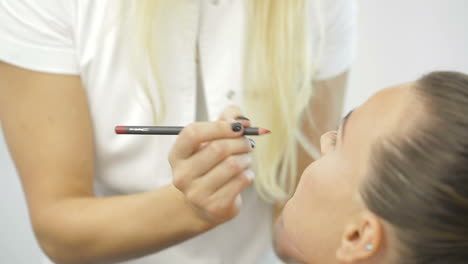 permanent make-up on her lips. portrait of lovely young woman getting permanent makeup on her lips