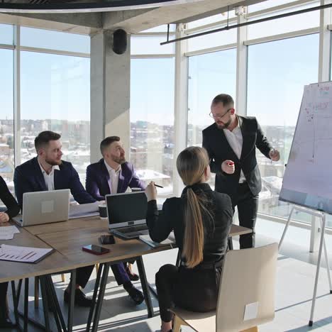 teamwork in the meeting room. developing strategies and new ideas using chart. team of professionals in the light office