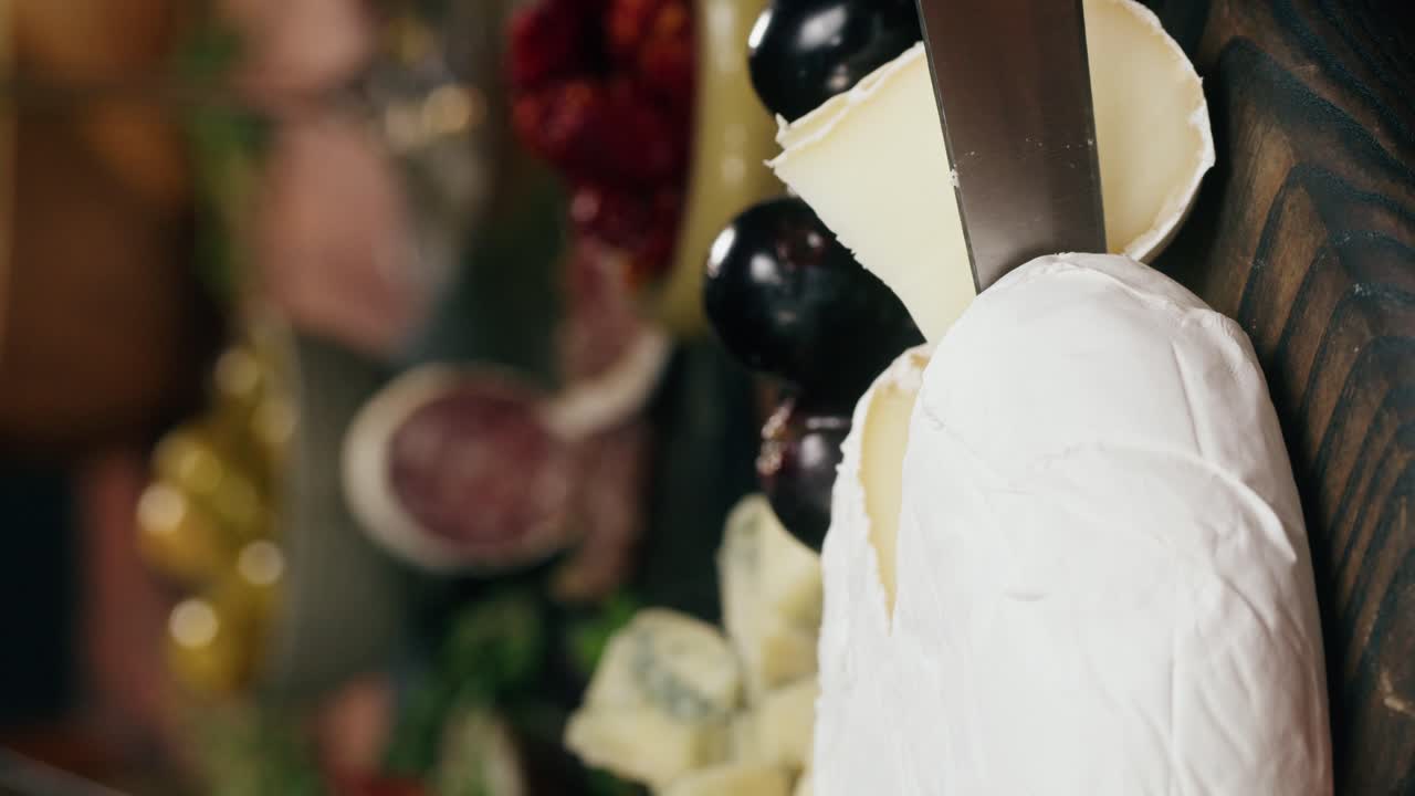 Close up of charcuterie board with cheese, fruit, and knife