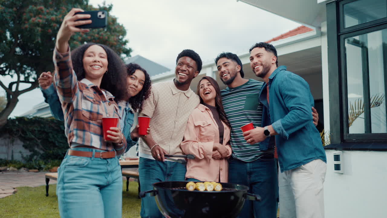 Group of friends taking a selfie at a barbecue
