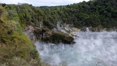 nubes de vapor caliente y brumoso que se elevan desde la piscina caliente sulfúrica del lago de sartén en el valle de la grieta volcánica de waimangu, rotorua, nueva zelanda aotearoa