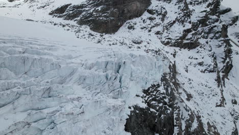 Drone-landscape-view-of-the-cracks-of-the-face-of-a-large-glacier-in-winter-in-the-Alps