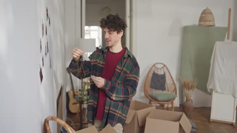 man moving and decorating a new apartment
