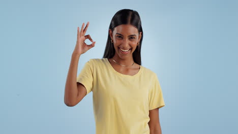 Okay-sign,-face-and-woman-in-studio-for-vote