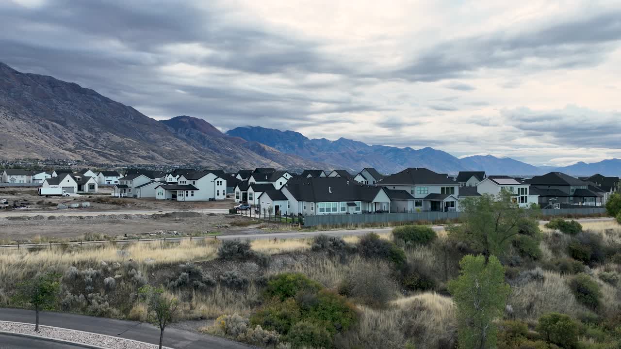 Rising Aerial Reveal Of New Housing Community From Behind A Tree In Autumn At Highland, Utah, USA