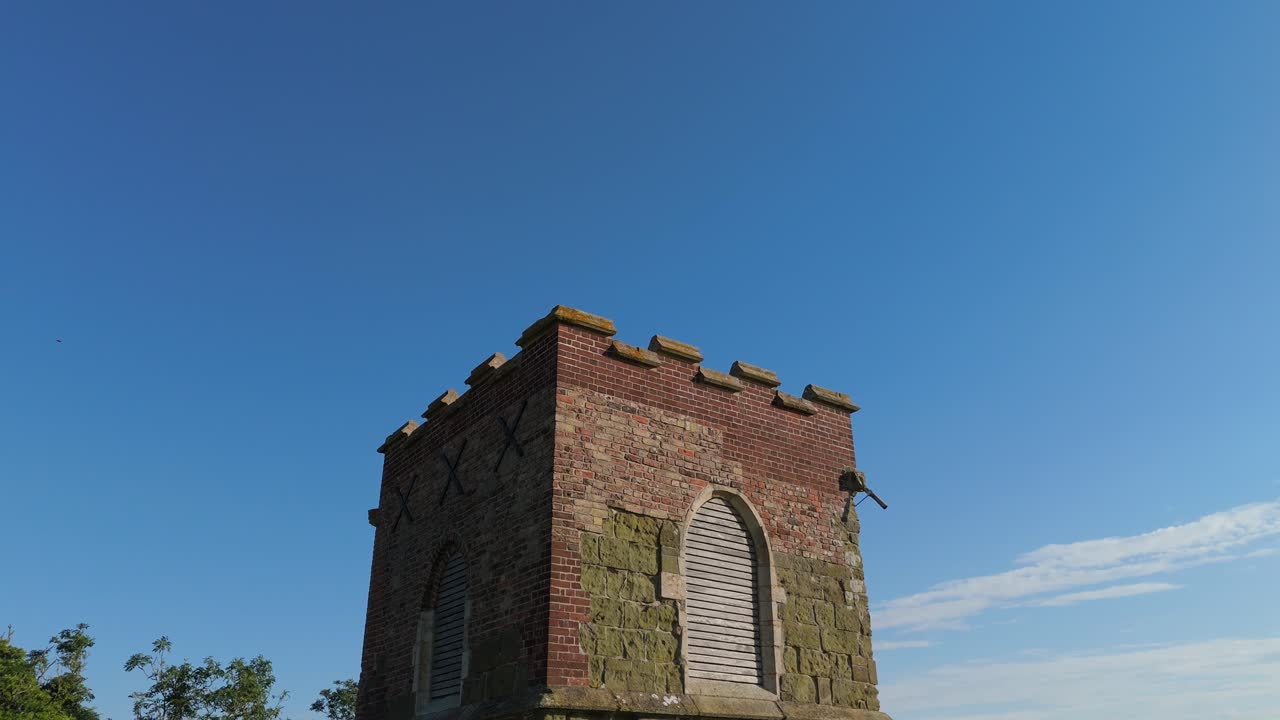 Quaint rural village church is a small, picturesque rural setting. St Mary's Church on the High Street of Burwell a peaceful atmosphere, beautiful natural landscapes, rolling hills. Rooftop views