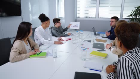 group of managers discussing progress at business meeting