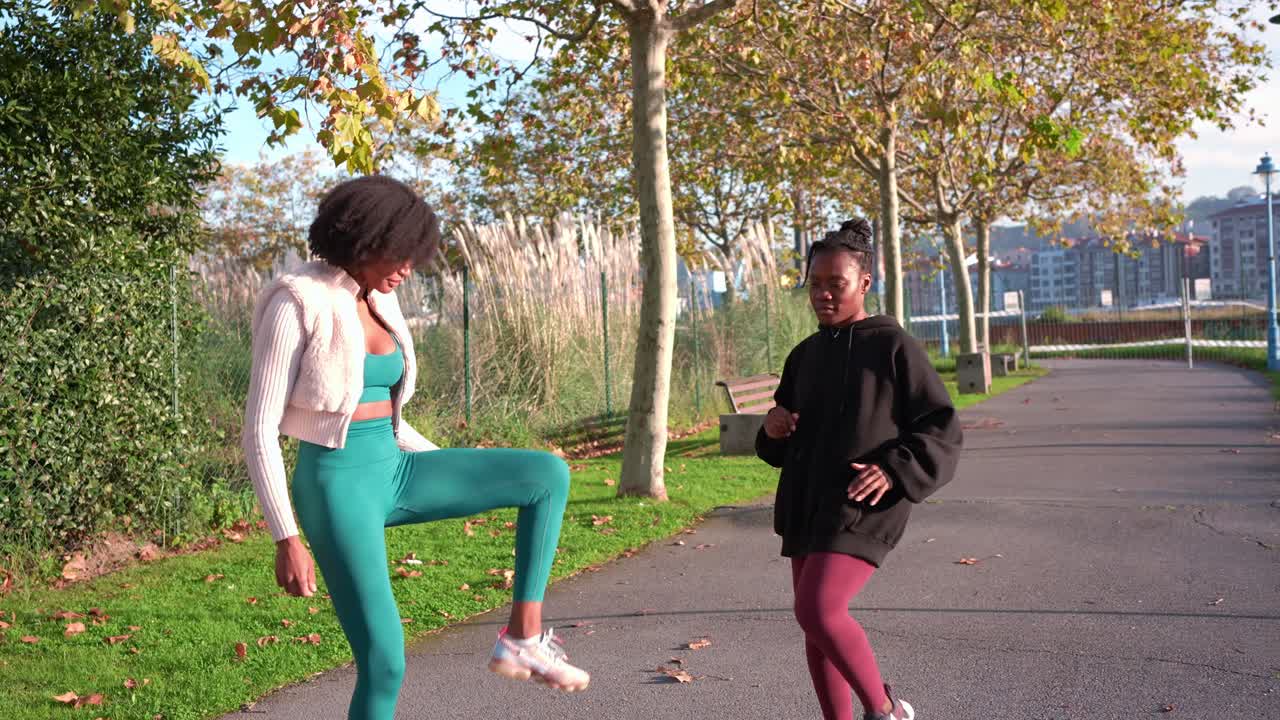 Two women exercising in the park