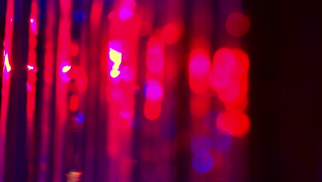 defocused close up shot of sparkling tinsel curtain in night club or disco with flashing strobe lighting 4