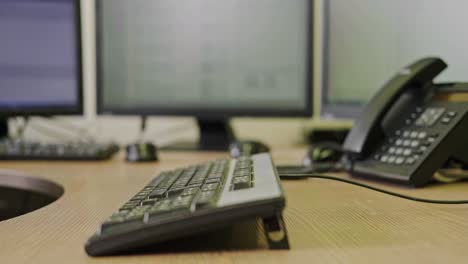 a businessman man with torn money dollars in his hands is working on a computer keyboard at an office desk, close-up