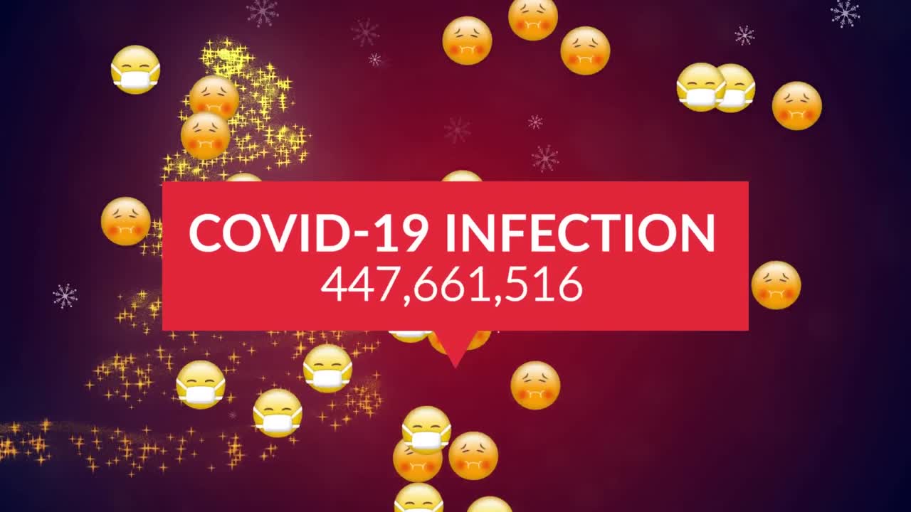 Testo 'infezione da Covid-19' ed emoji di faccine che cadono su una stella cadente che forma un albero di Natale.
