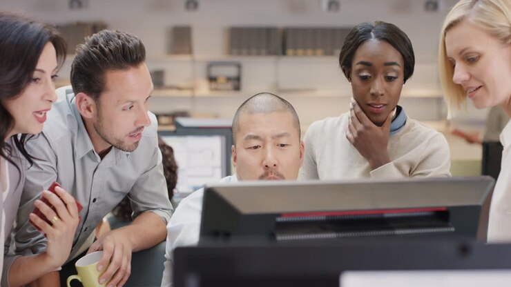 Creative business team meeting in modern glass office multi ethnic group of people working over computer screen on combined teamwork project