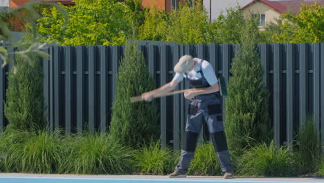 gardener cleaning poolside area