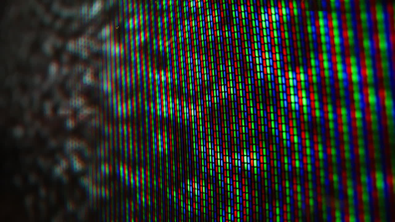 Analog noise flickering television emitting signal in dark space macro view