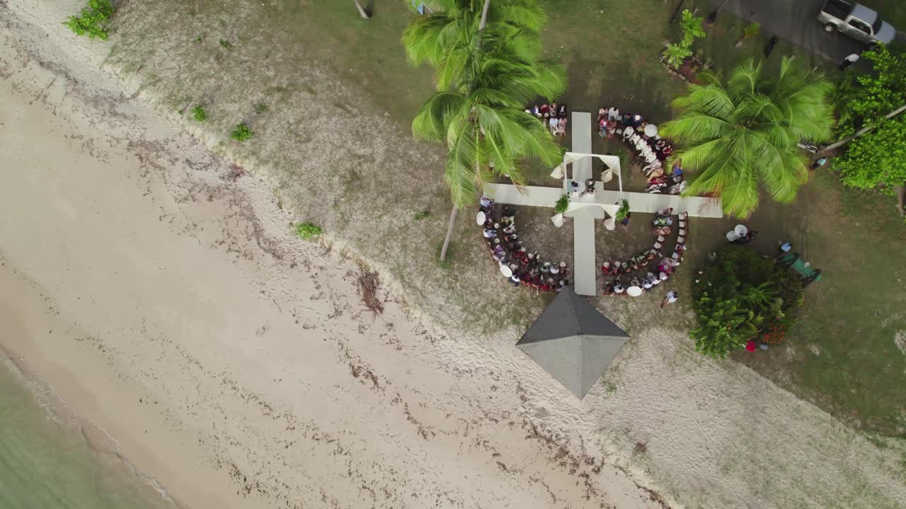 Stunning aerial shot of a wedding reception in Tobago’s clear waters and white sandy beach in the heart of the Caribbean.