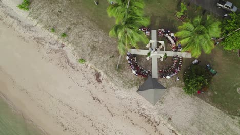 stunning aerial shot of a wedding reception in tobago’s clear waters and white sandy beach in the heart of the caribbean.