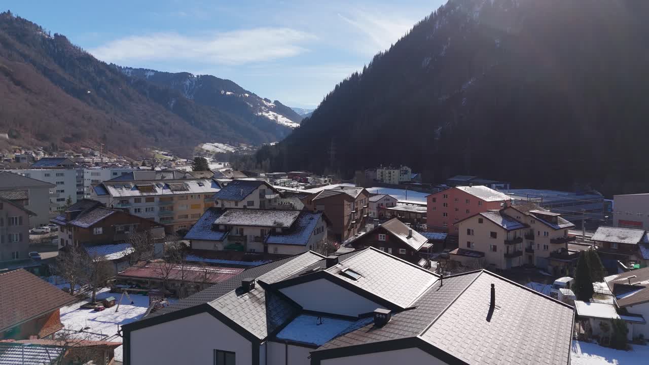 Snow-covered village in Schiers, Switzerland, with mountains and houses in winter