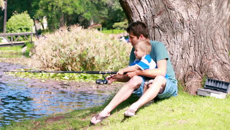 man teaches to his son fishing