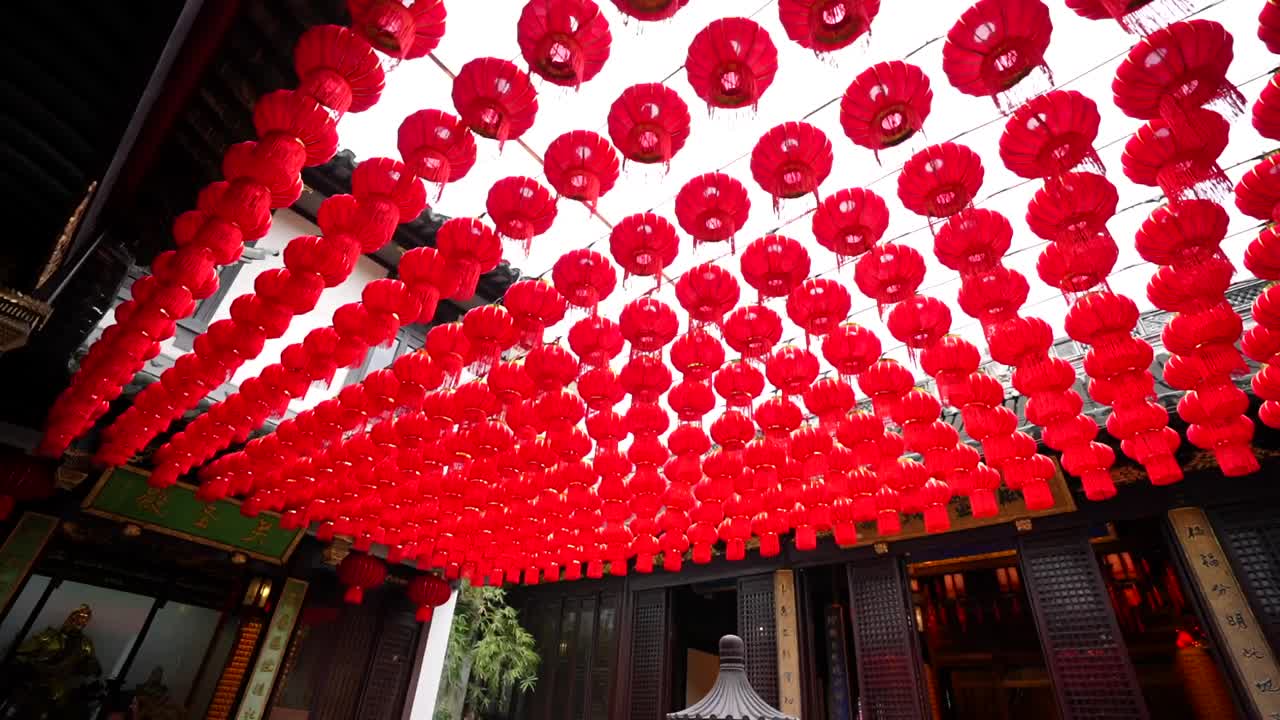 Panning right over twelve rows of red lanterns in the City God Temple yard, Chenghuangmiao. Shanghai, China