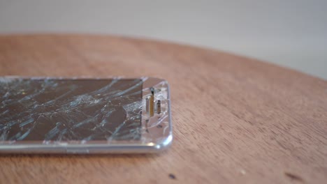 smartphone with a severely cracked and shattered screen