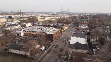 Local-American-town-with-majestic-Ambassador-bridge-in-horizon,-aerial-drone-view